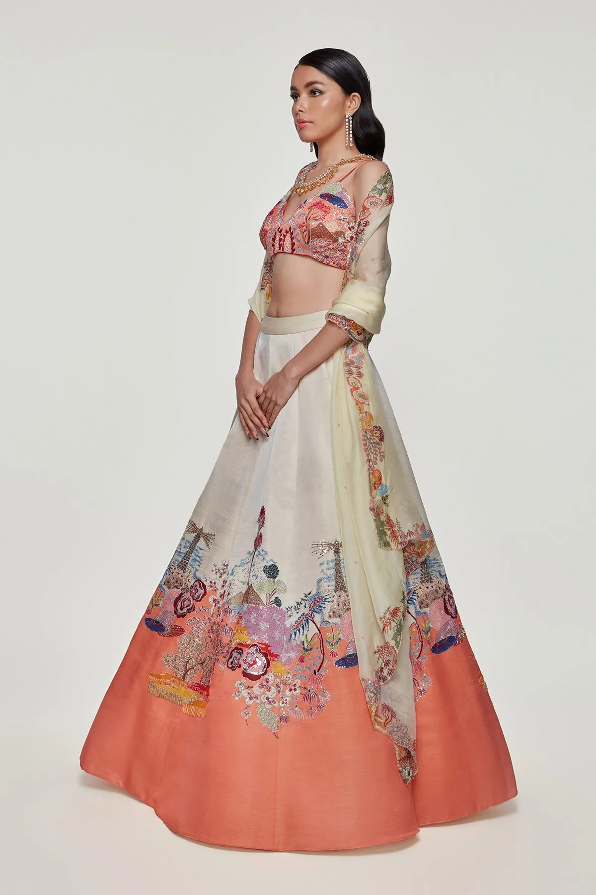 Ivory And Peach Divergence Silk Appliquéd And Embellished Lehenga With Blouse And Cutwork Organza Dupatta